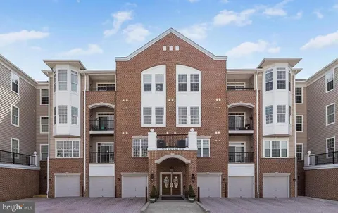 a front view of a residential apartment building with a yard