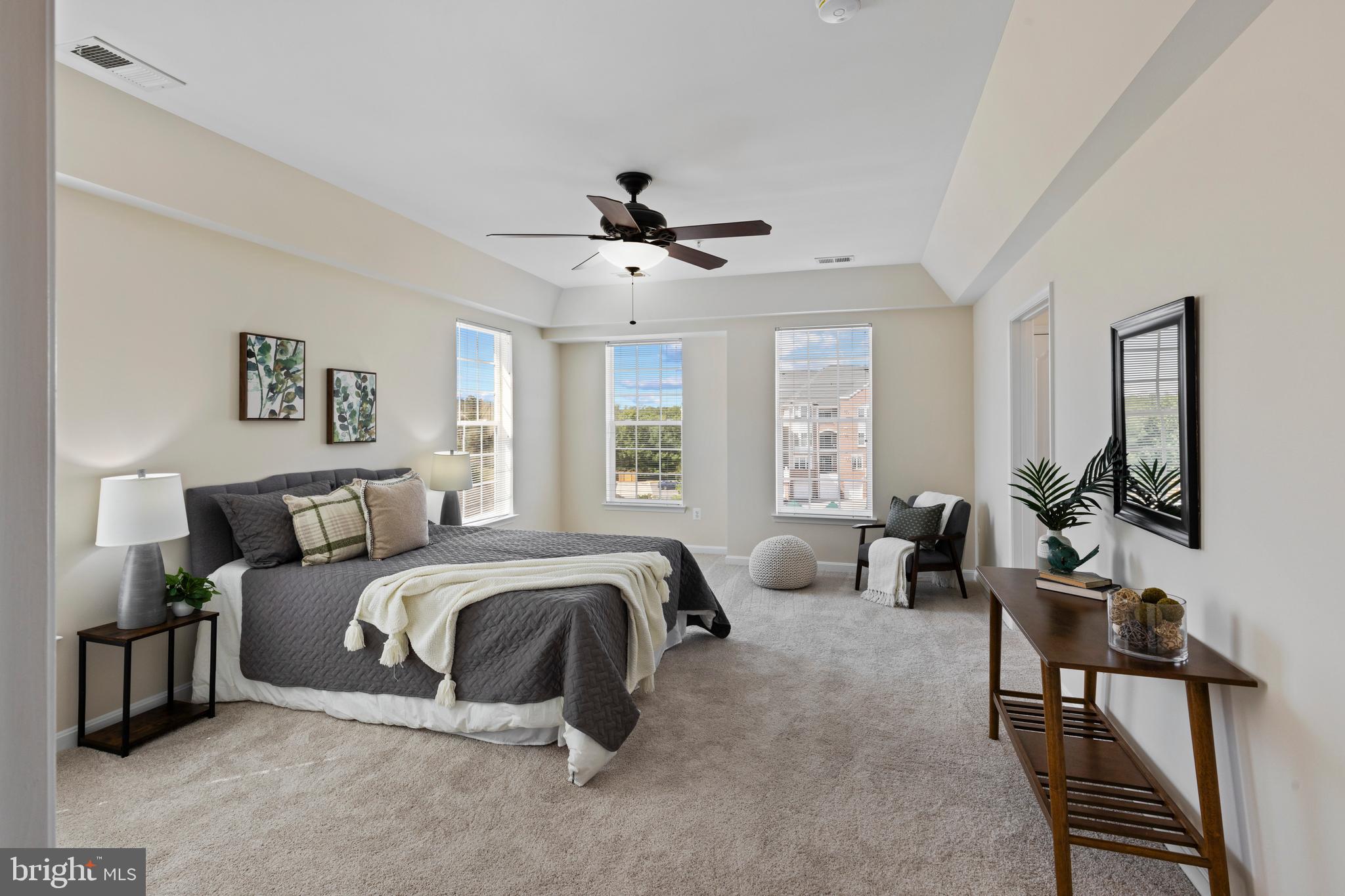 7315 Brookview Road, Unit 407 Elkridge, MD 21075 - Photo 16 of 33 a spacious bedroom with a bed a couch and a chandelier