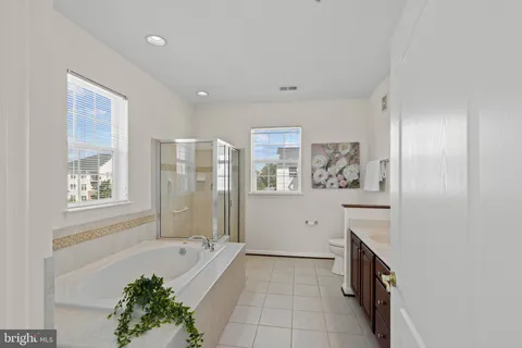 a spacious bathroom with a bathtub and a shower