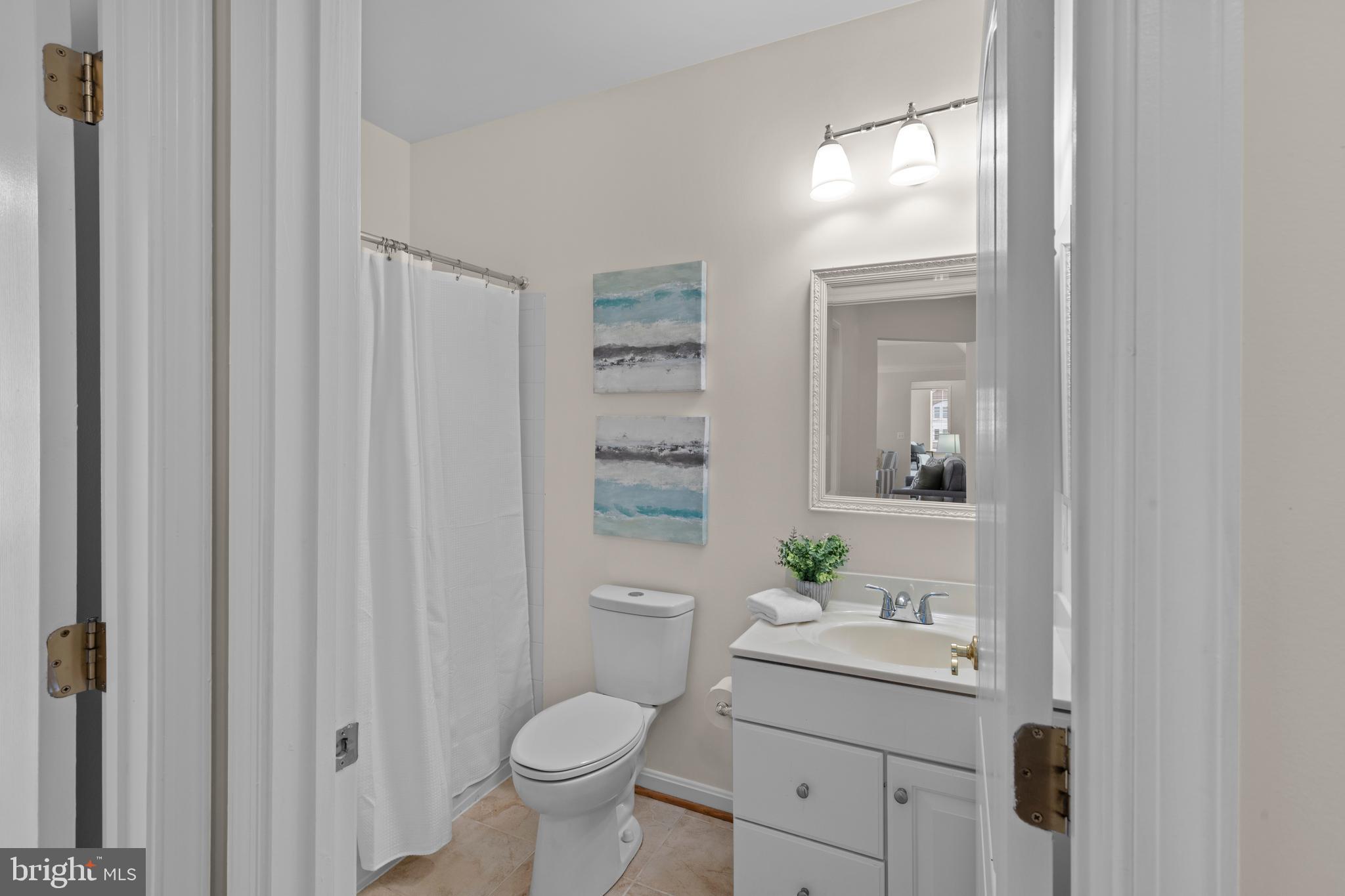 7315 Brookview Road, Unit 407 Elkridge, MD 21075 - Photo 22 of 33 a bathroom with a sink a toilet and a mirror