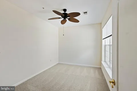 a view of room with a ceiling fan