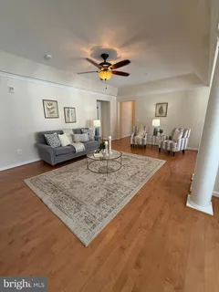 a living room with furniture and a rug