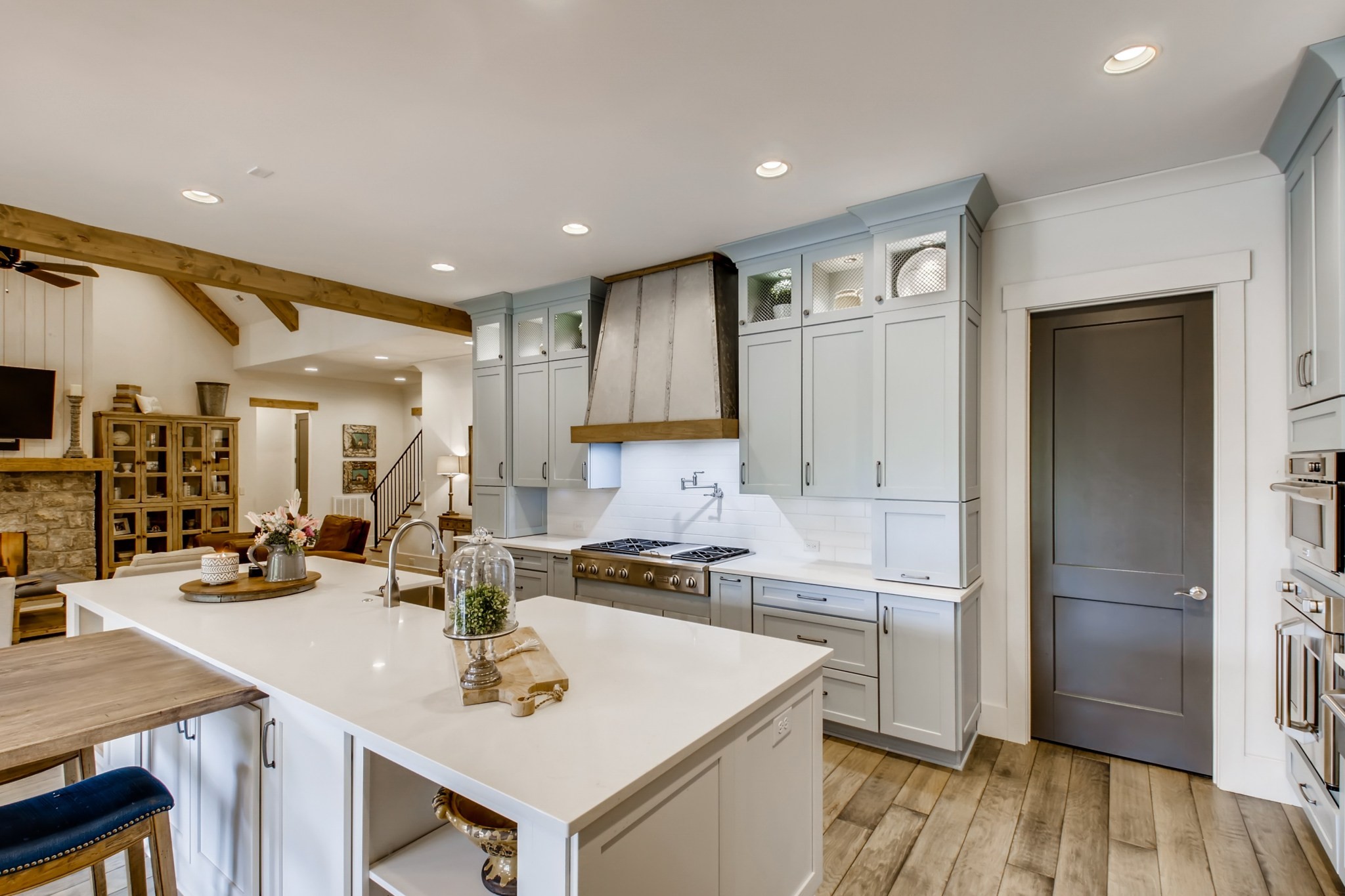 637 Legends Crest Drive Franklin, TN 37069 - Photo 14 of 50 a kitchen with a sink a stove a refrigerator and white cabinets with wooden floor