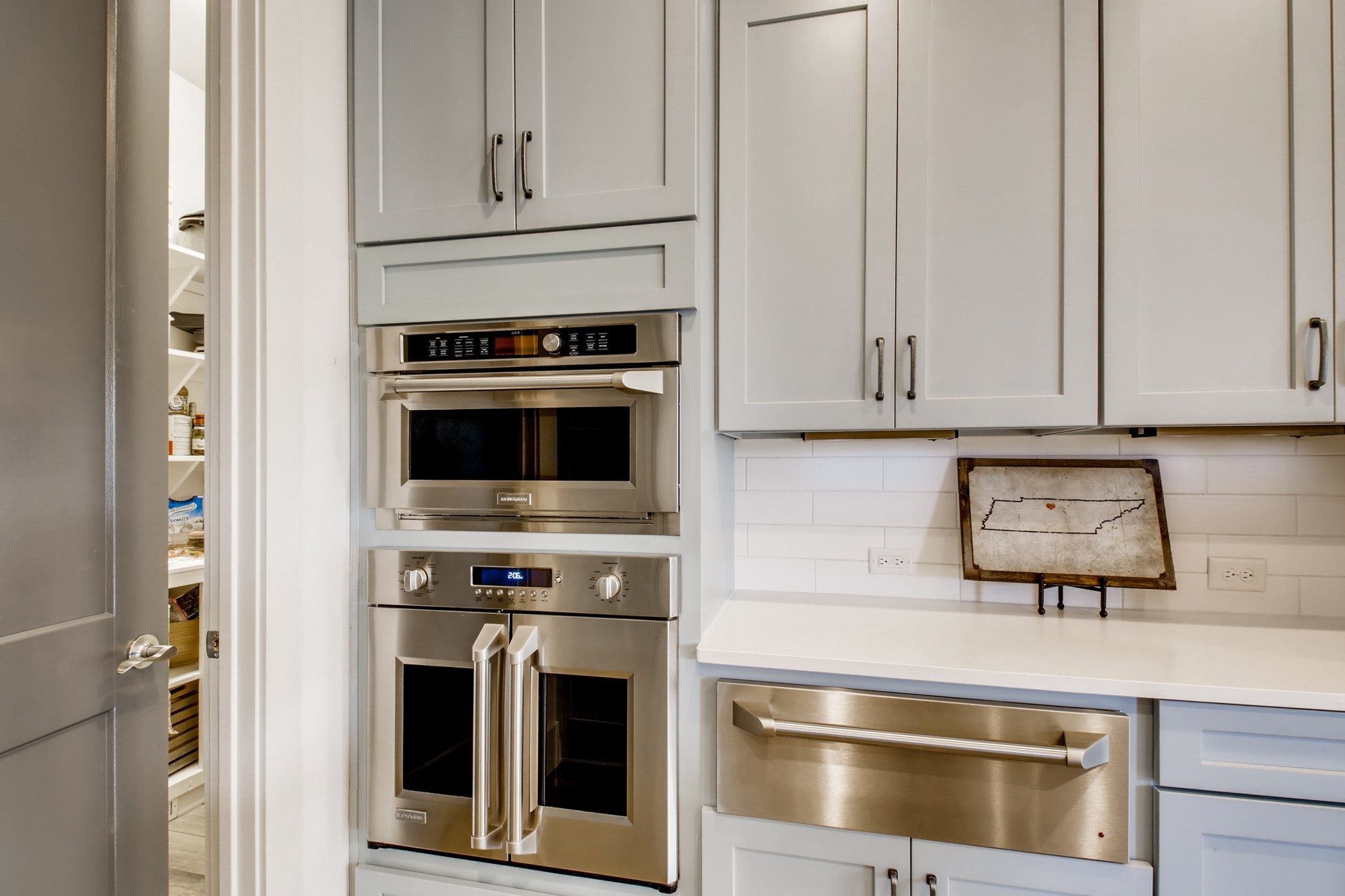 637 Legends Crest Drive Franklin, TN 37069 - Photo 15 of 50 a kitchen with stainless steel appliances granite countertop a stove and a microwave