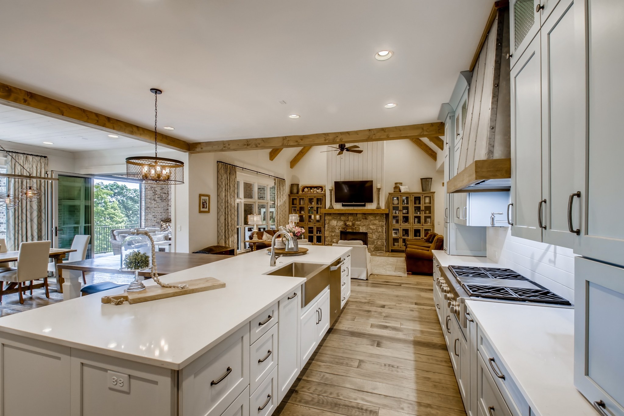 637 Legends Crest Drive Franklin, TN 37069 - Photo 16 of 50 a large kitchen with stainless steel appliances a stove a sink dishwasher and a dining table with the living room view