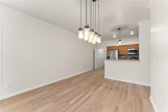 a view of a kitchen with a dishwasher cabinets and wooden floor