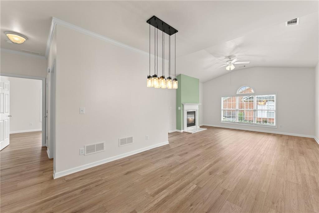 119 Holiday Road, Unit 603 Buford, GA 30518 - Photo 13 of 34 a view of an empty room with wooden floor and a window