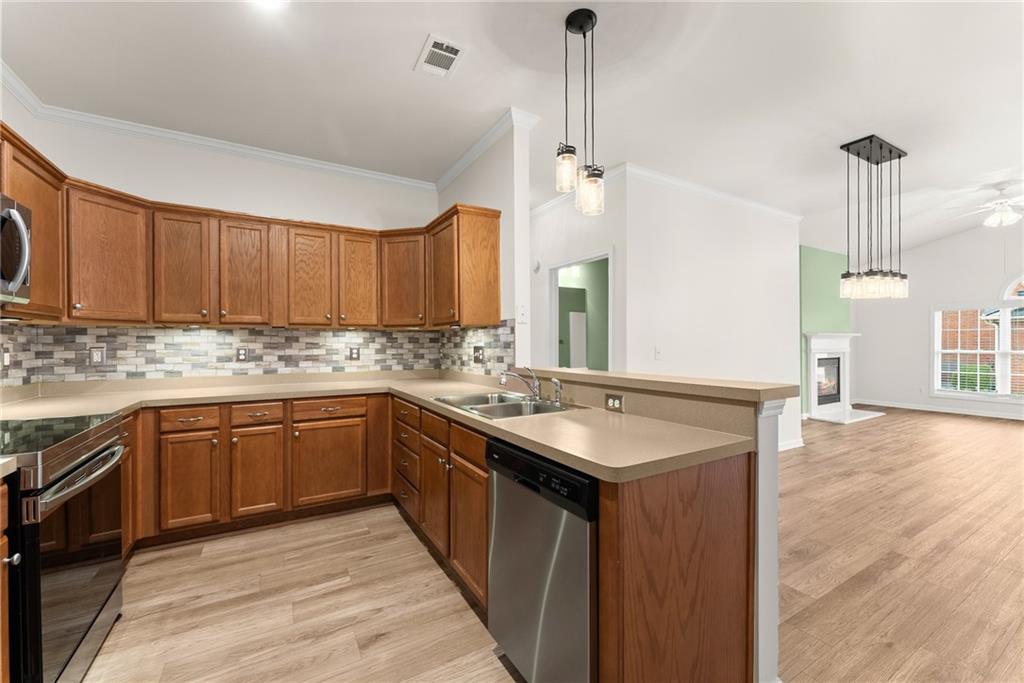 119 Holiday Road, Unit 603 Buford, GA 30518 - Photo 16 of 34 a kitchen with sink cabinets and wooden floor