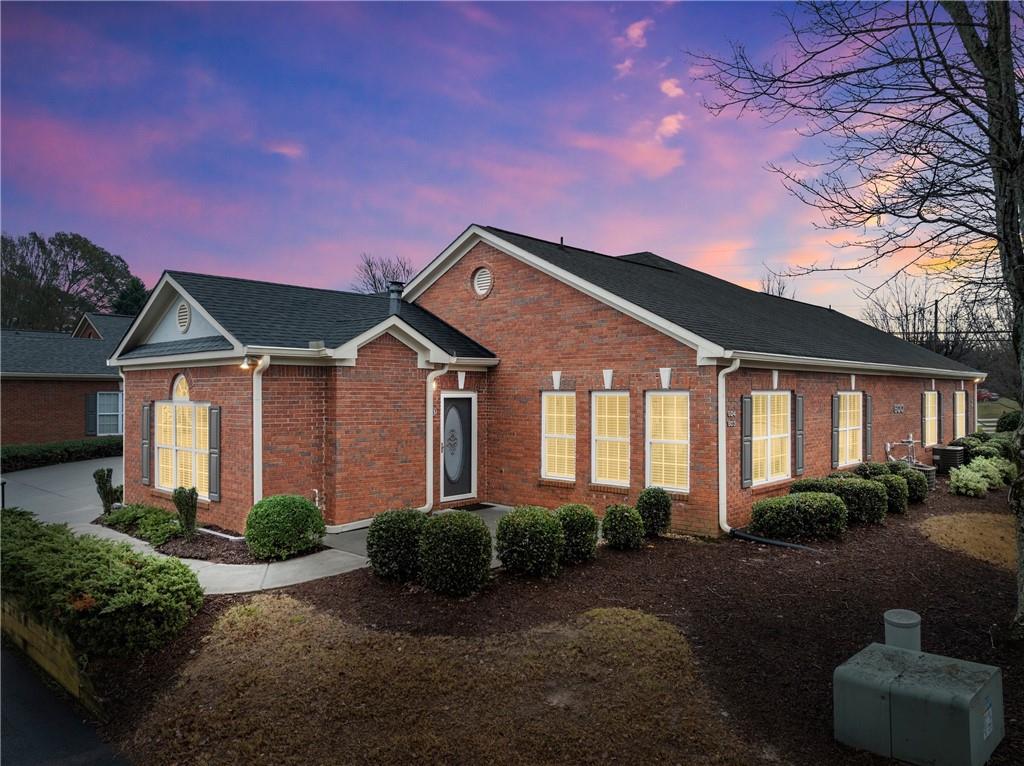 119 Holiday Road, Unit 603 Buford, GA 30518 - Photo 2 of 34 a front view of a house with garden