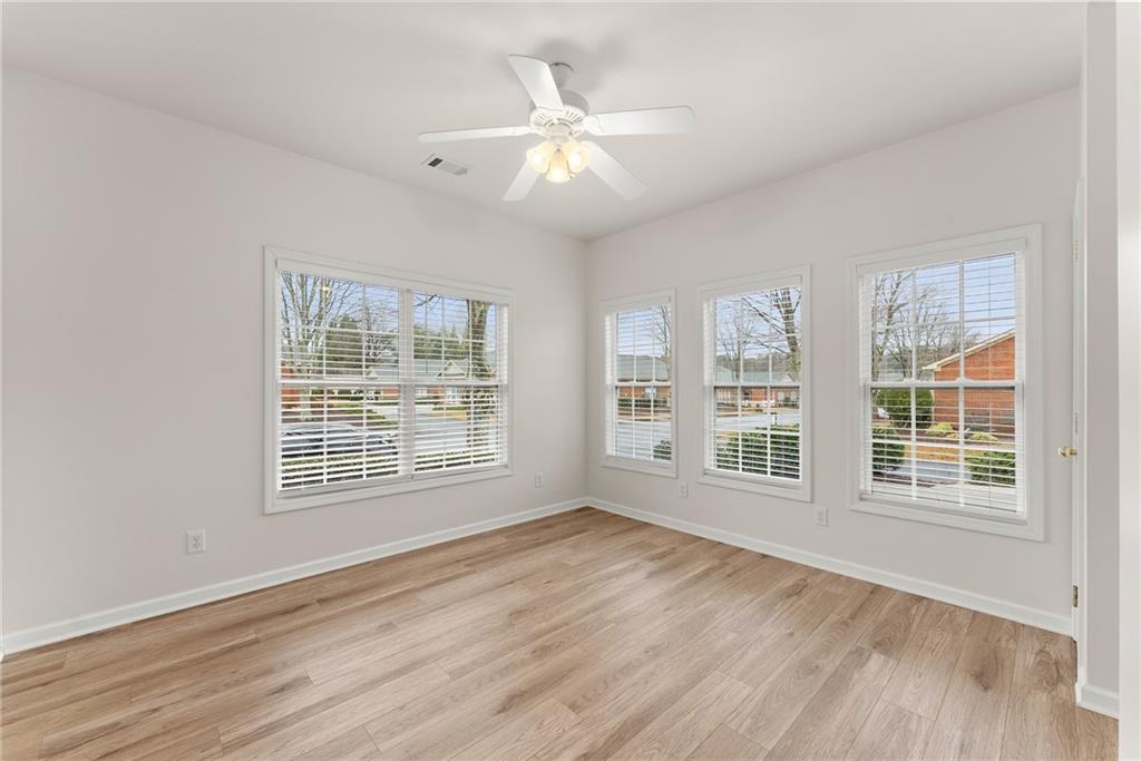 119 Holiday Road, Unit 603 Buford, GA 30518 - Photo 21 of 34 an empty room with wooden floor and windows
