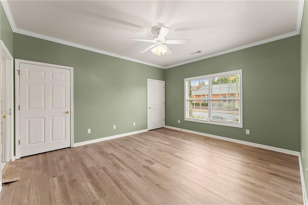 119 Holiday Road, Unit 603 Buford, GA 30518 - Photo 23 of 34 a view of an empty room with wooden floor and a window