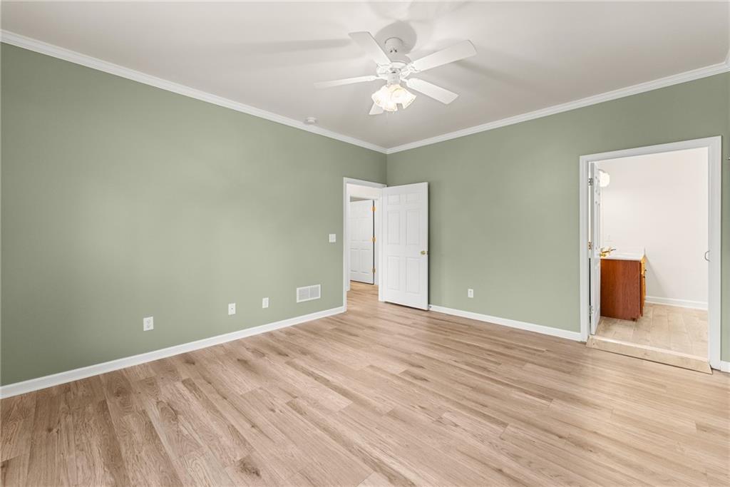 119 Holiday Road, Unit 603 Buford, GA 30518 - Photo 24 of 34 a view of an empty room with wooden floor