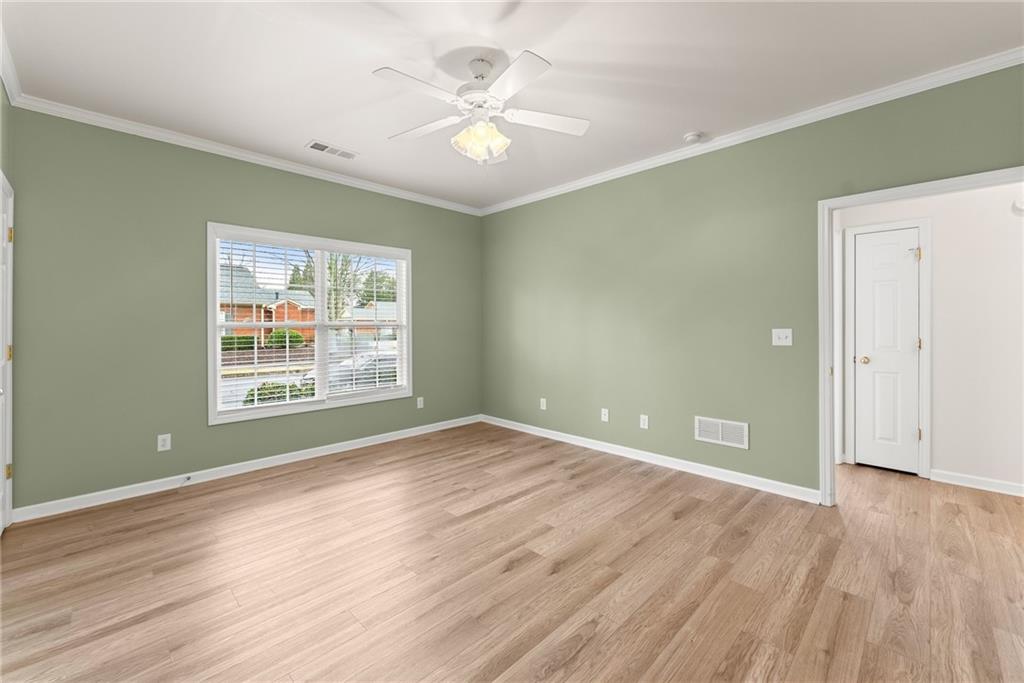 119 Holiday Road, Unit 603 Buford, GA 30518 - Photo 26 of 34 an empty room with wooden floor and windows