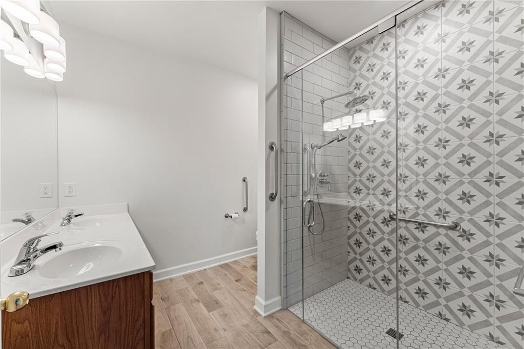 119 Holiday Road, Unit 603 Buford, GA 30518 - Photo 27 of 34 a bathroom with a sink and shower