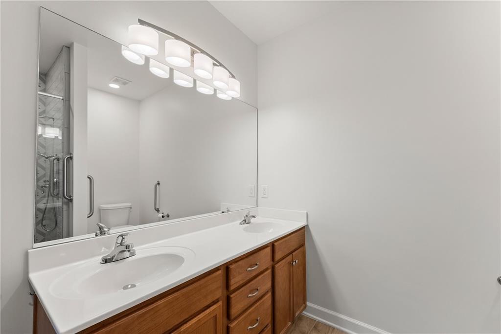 119 Holiday Road, Unit 603 Buford, GA 30518 - Photo 28 of 34 a bathroom with a sink vanity and a mirror