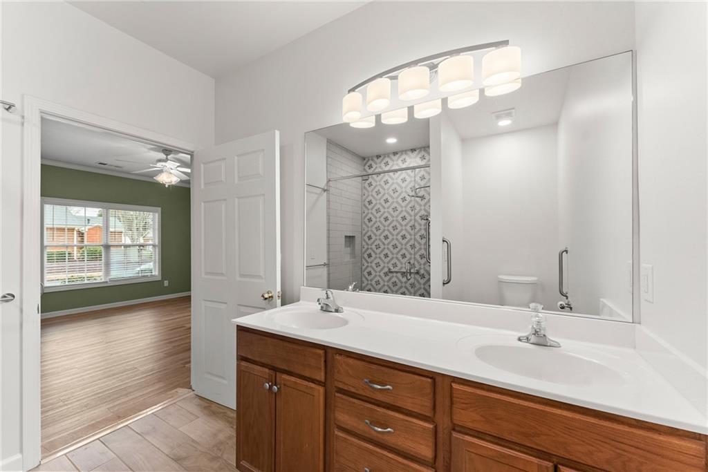 119 Holiday Road, Unit 603 Buford, GA 30518 - Photo 29 of 34 a bathroom with a sink double vanity and a mirror