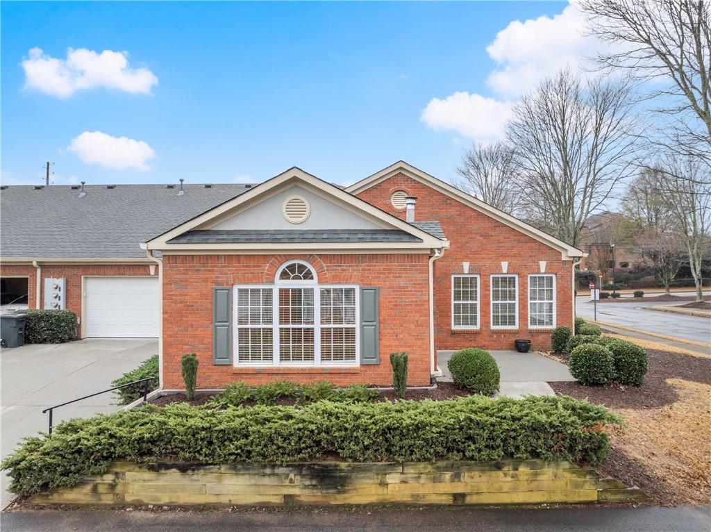 119 Holiday Road, Unit 603 Buford, GA 30518 - Photo 3 of 34 a front view of a house with a yard