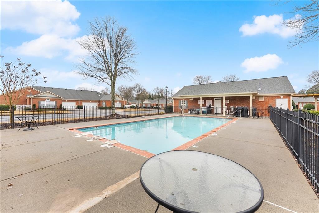 119 Holiday Road, Unit 603 Buford, GA 30518 - Photo 31 of 34 a view of swimming pool with outdoor seating