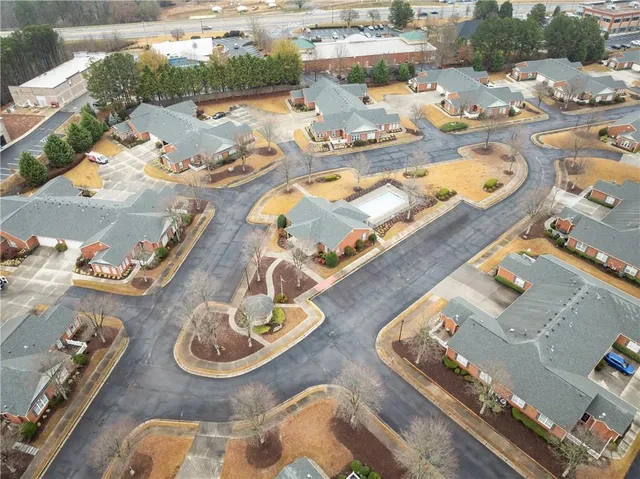 an aerial view of residential houses with outdoor space