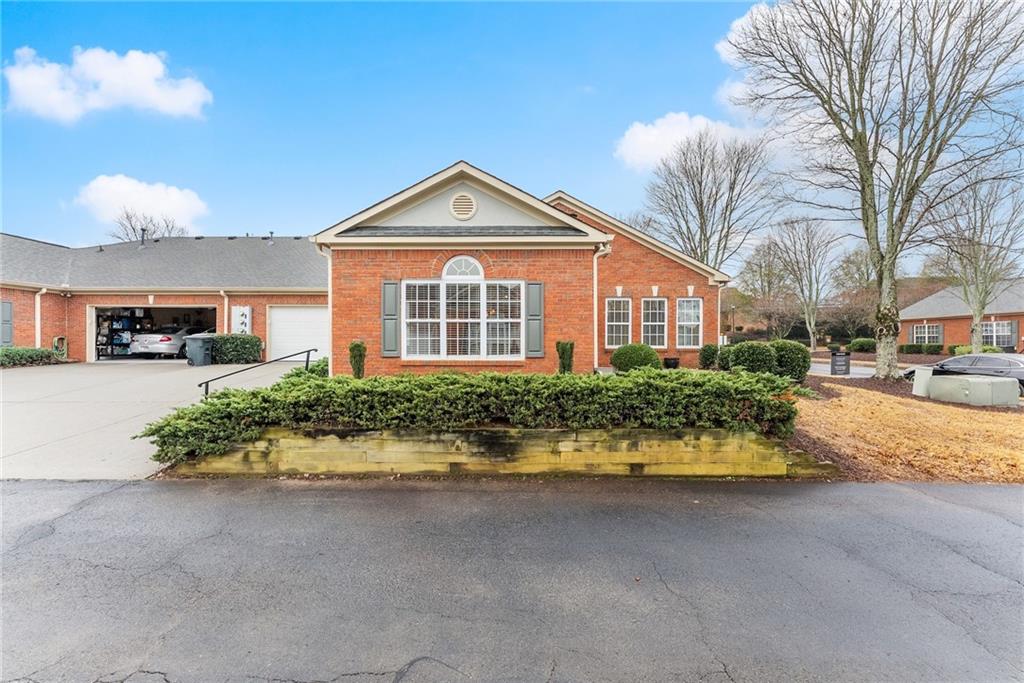 119 Holiday Road, Unit 603 Buford, GA 30518 - Photo 6 of 34 a front view of a house with a yard