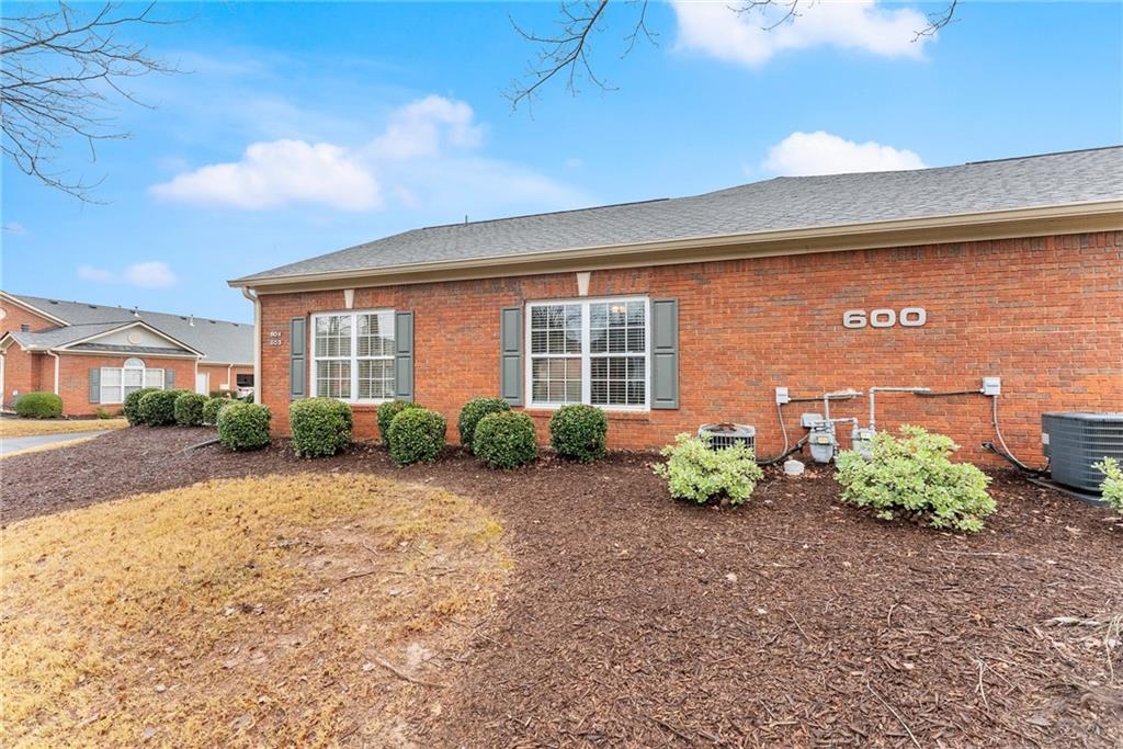 119 Holiday Road, Unit 603 Buford, GA 30518 - Photo 8 of 34 a front view of a house with garden