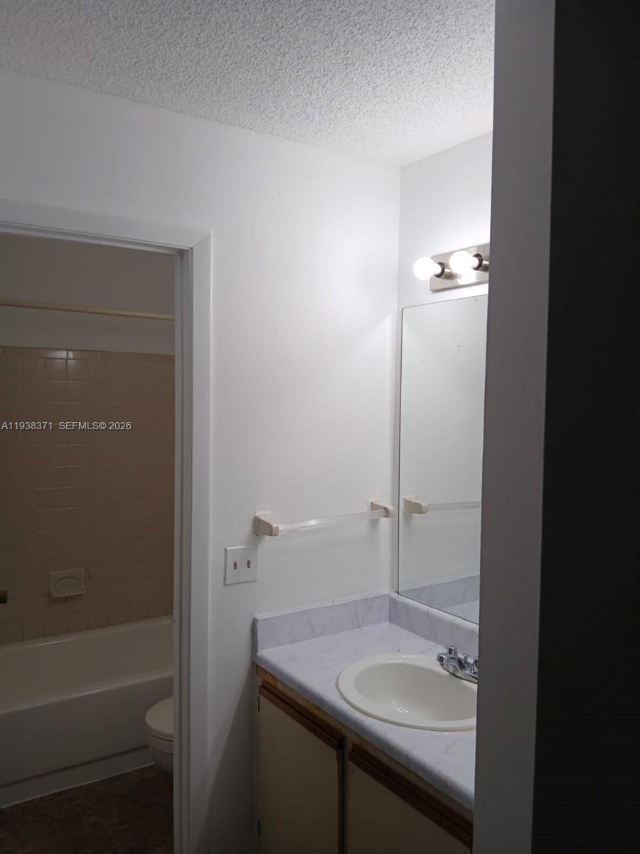 4521 West McNab Road, Unit 21 Pompano Beach, FL 33069 - Photo 11 of 18 a bathroom with a sink and a mirror