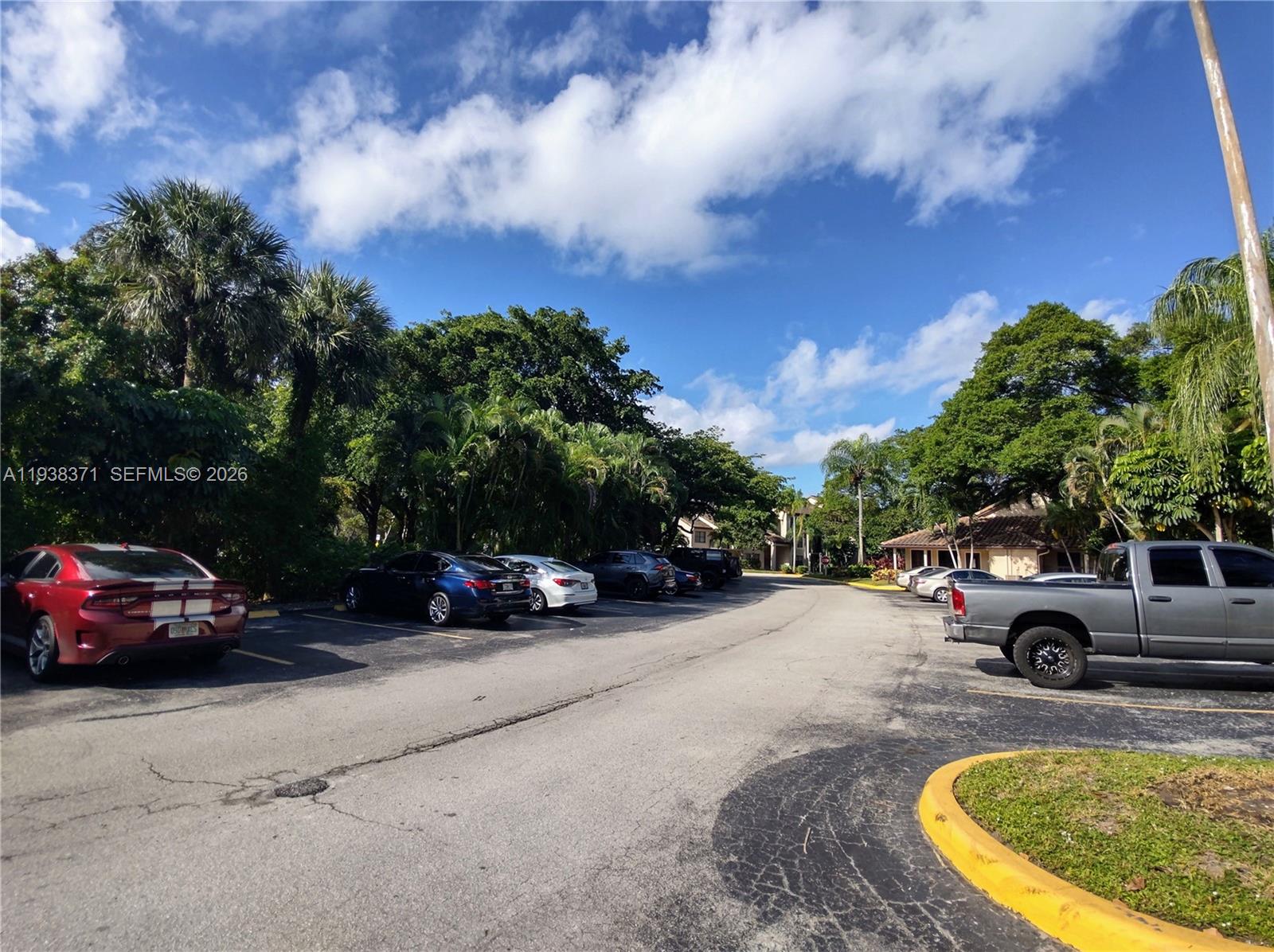 4521 West McNab Road, Unit 21 Pompano Beach, FL 33069 - Photo 17 of 18 an outdoor view with a car parked in the street