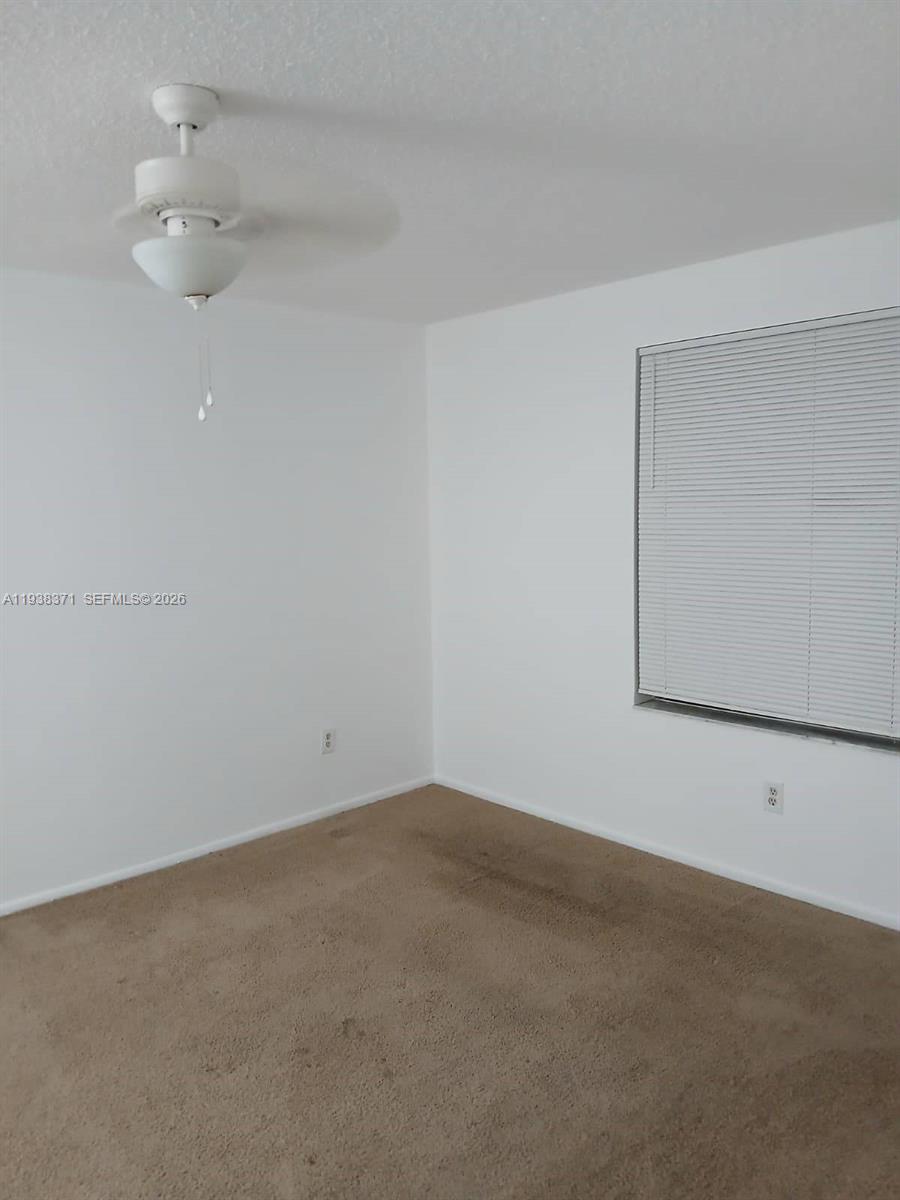 4521 West McNab Road, Unit 21 Pompano Beach, FL 33069 - Photo 9 of 18 an empty room with a empty space