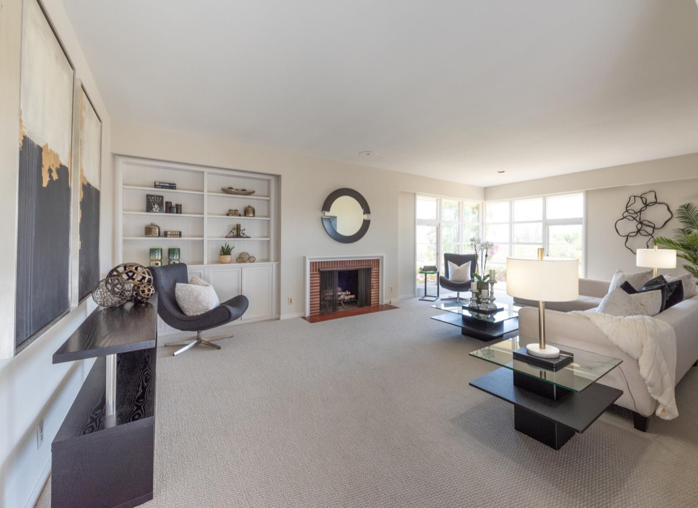 860 Longview Road Hillsborough, CA 94010 - Photo 10 of 42 a living room with furniture gym equipment and a fireplace