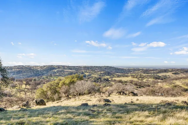 a view of a large building with mountains in the background
