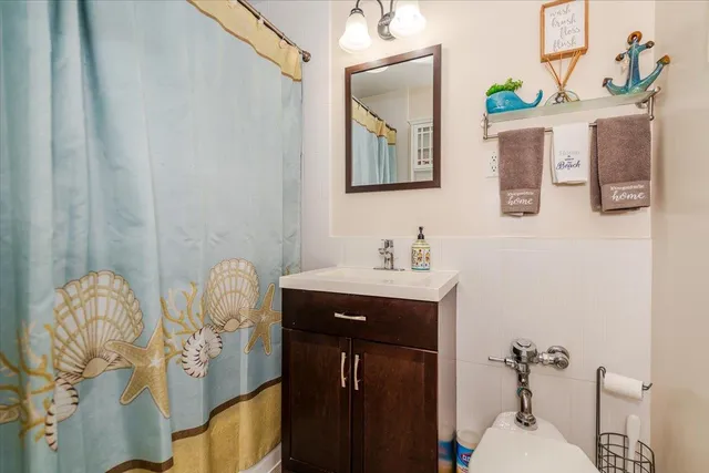 a bathroom with a sink mirror and vanity