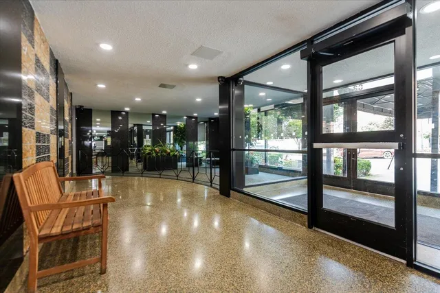 a view of a lobby with furniture and floor to ceiling window