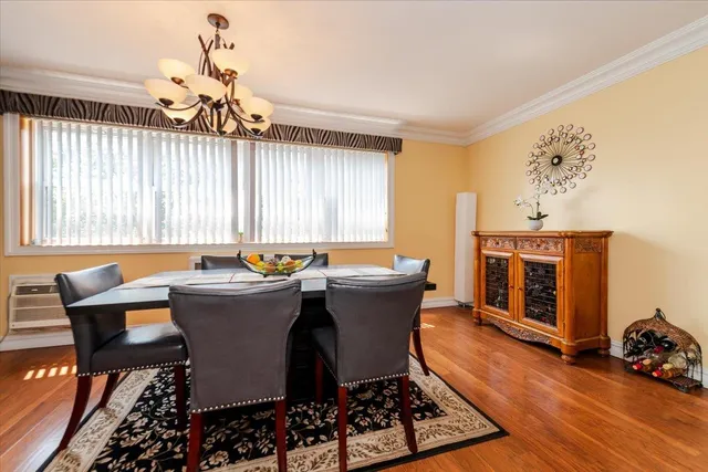 a dining room with a wooden table and chairs