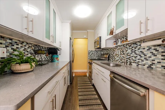 a kitchen with lots of counter top space and stainless steel appliances