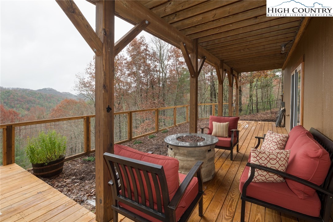 196 Wagon Ridge Road Ferguson, NC 28624 - Photo 11 of 18 a balcony with furniture and a potted plant