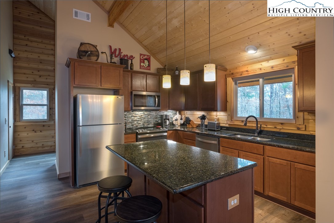 196 Wagon Ridge Road Ferguson, NC 28624 - Photo 3 of 18 a kitchen with stainless steel appliances granite countertop a sink refrigerator and cabinets