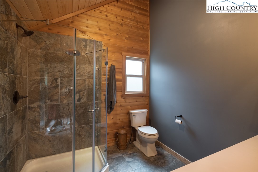 196 Wagon Ridge Road Ferguson, NC 28624 - Photo 9 of 18 a bathroom with a toilet and a shower