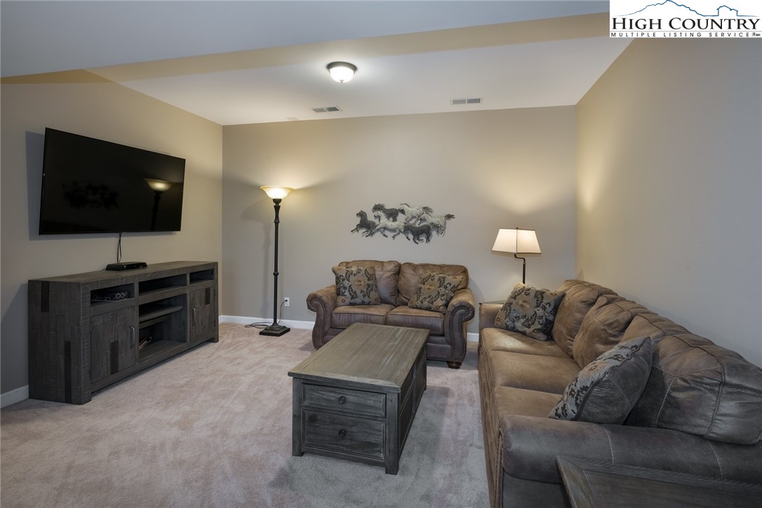 196 Wagon Ridge Road Ferguson, NC 28624 - Photo 10 of 18 a living room with furniture and a flat screen tv
