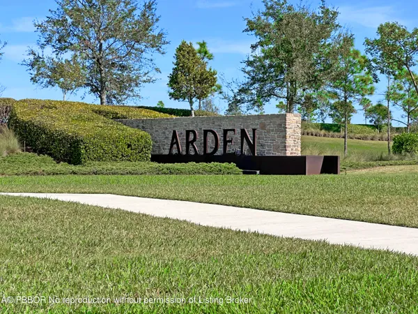 a front view of a house with a yard and potted plants
