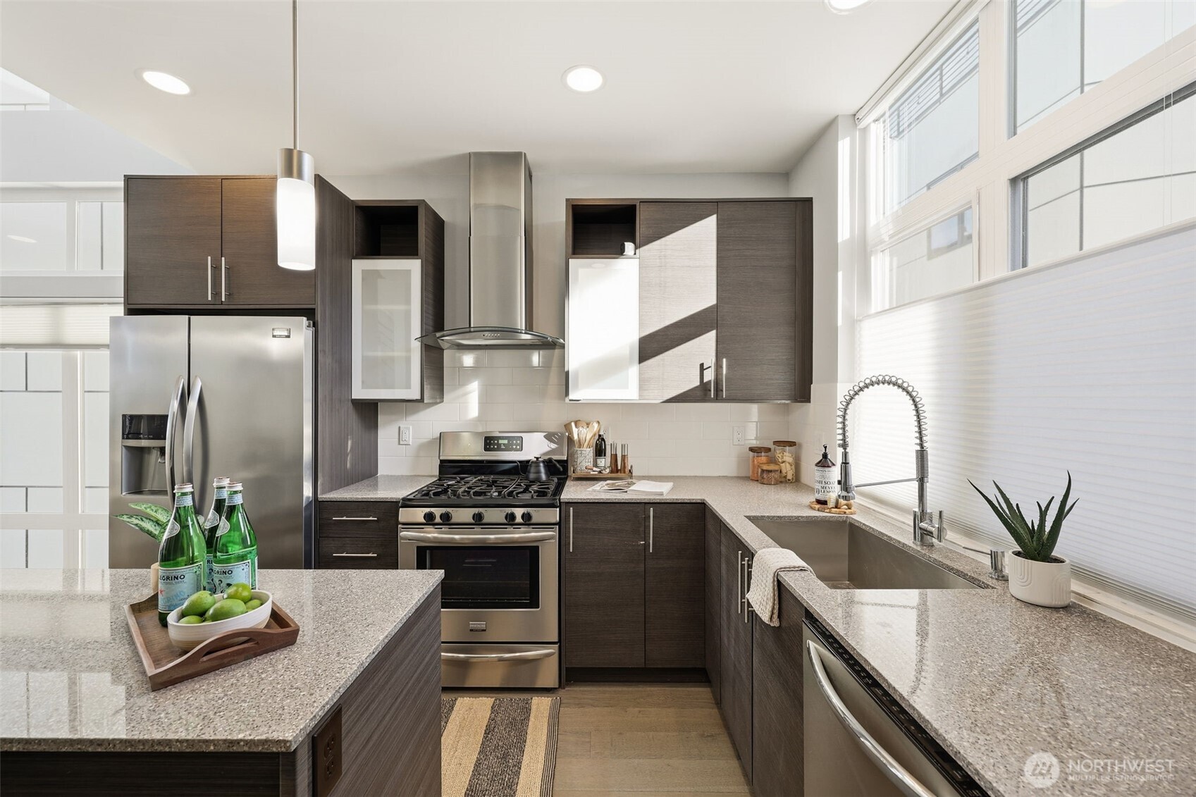 3010 63rd Avenue Southwest, Unit A Seattle, WA 98116 - Photo 13 of 38 a kitchen with stainless steel appliances granite countertop a sink a stove and a refrigerator