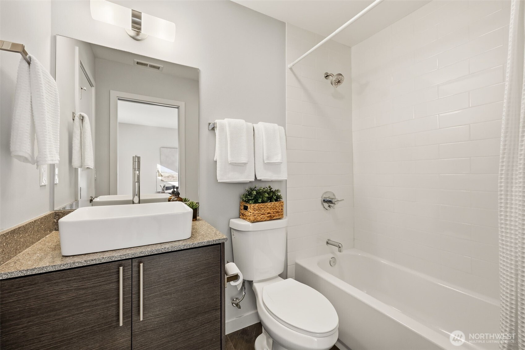 3010 63rd Avenue Southwest, Unit A Seattle, WA 98116 - Photo 25 of 38 a white toilet sitting next to a bathroom sink and tub