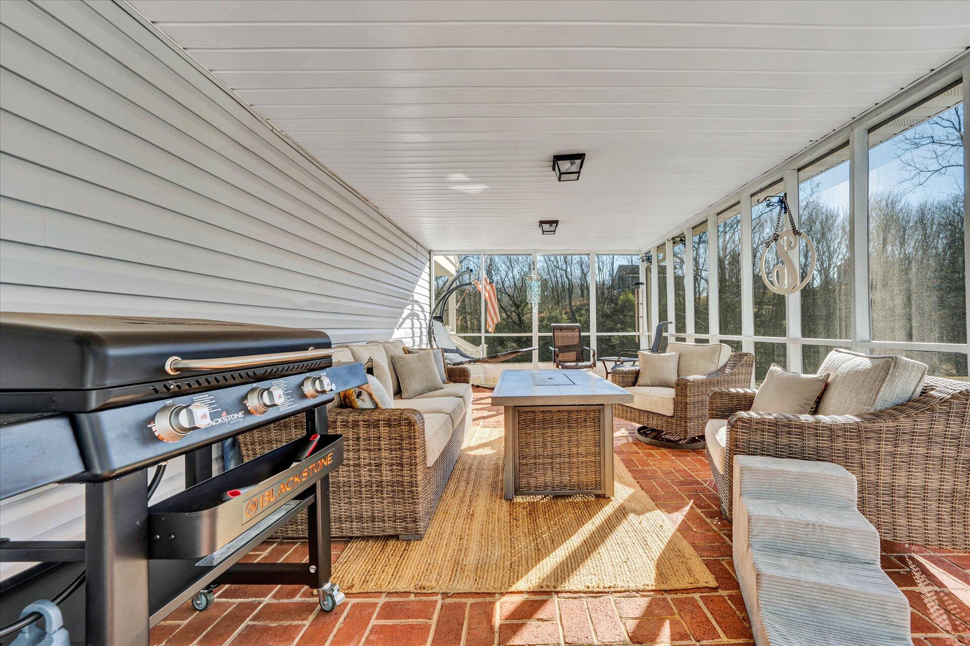 110 Nursery Road Boones Mill, VA 24065 - Photo 20 of 33 a living room with couches a large dining table and chairs with floor to ceiling window