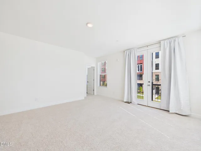 an empty room with a empty space and windows