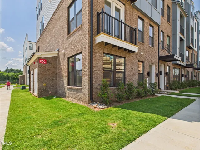 a view of a building with a yard