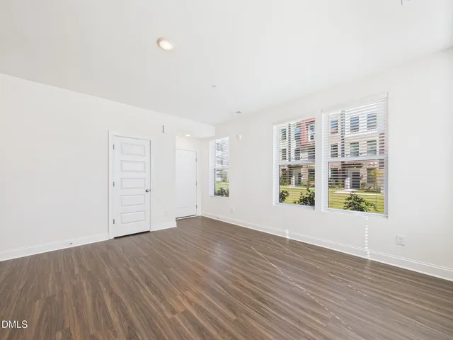 a view of a livingroom with wooden floor and stairs
