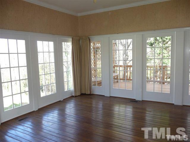 6908 Valley Ridge Court Raleigh, NC 27615 - Photo 14 of 25 a view of an empty room with wooden floor and a window