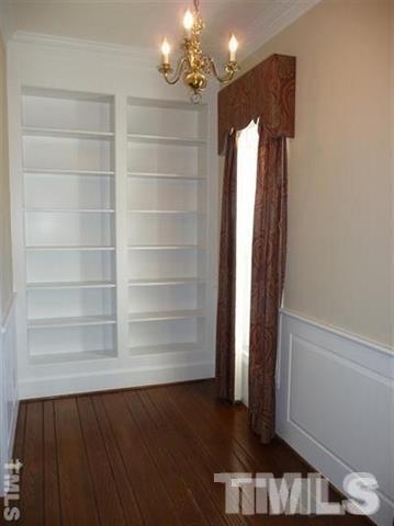 6908 Valley Ridge Court Raleigh, NC 27615 - Photo 8 of 25 a view of a room with a wooden floor and staircase