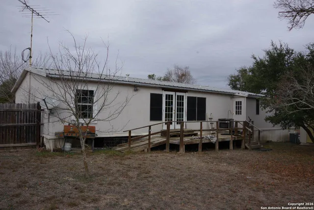 a backyard of a house with yard fire pit and outdoor seating