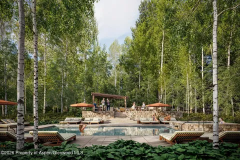 a view of a house with a yard patio and fire pit
