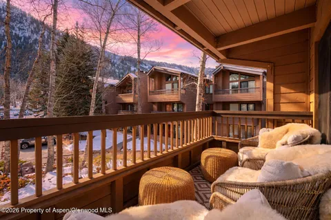 a balcony with couple of chairs